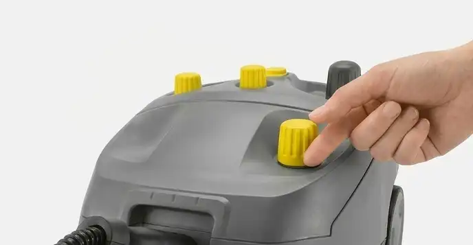 Nanoszenie roztworu czyszczącego na tapicerkę z odległości 15 cm przy użyciu pompy natryskowej odkurzacza Karcher